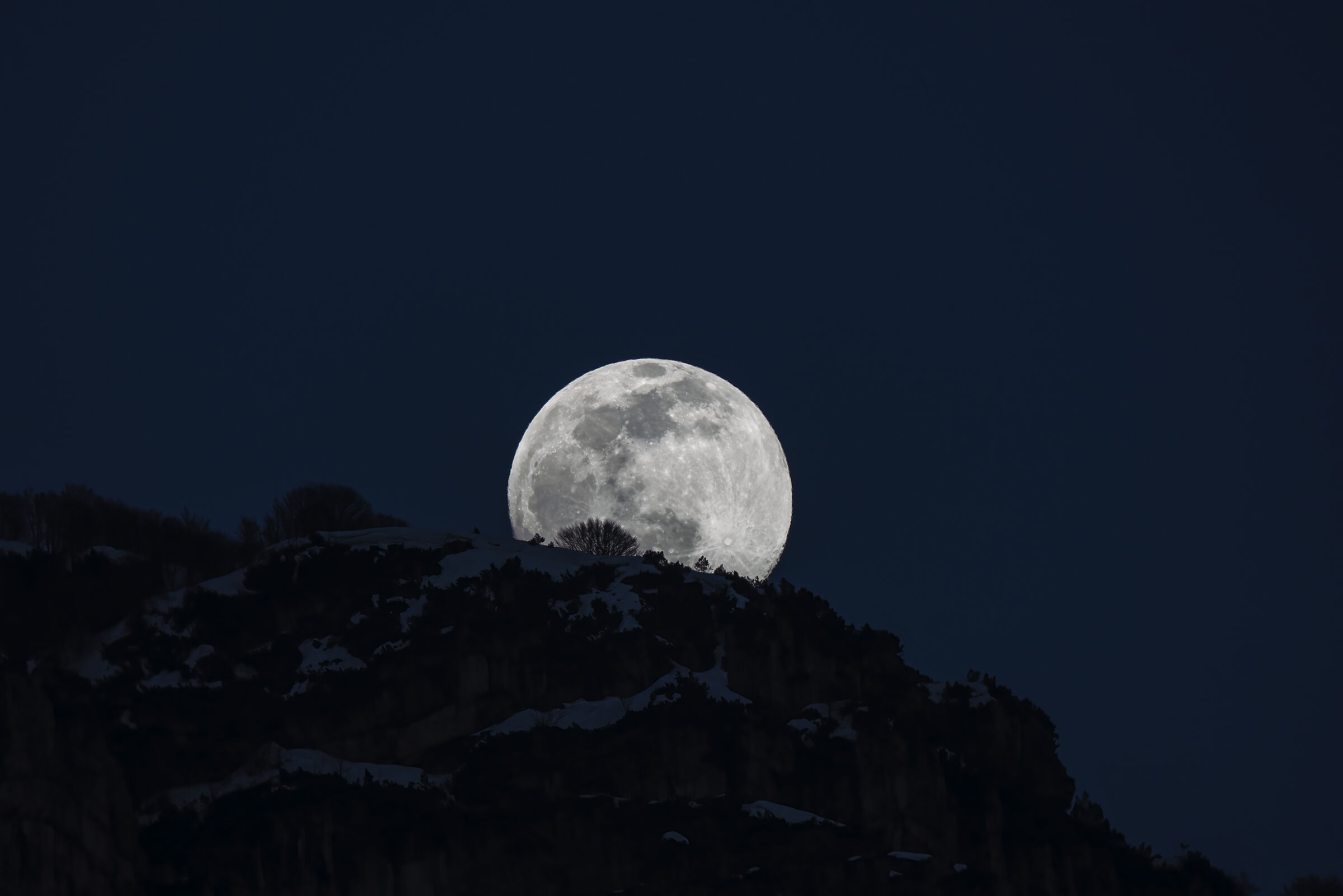 The moon rises from the mountain...