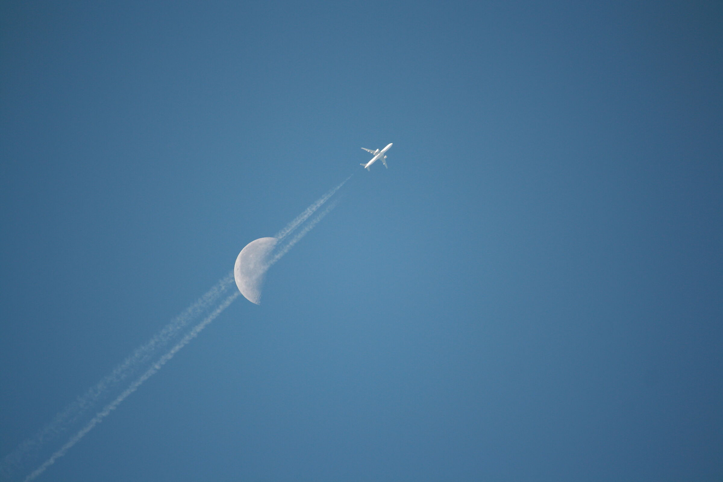 Moon pierced by plane...