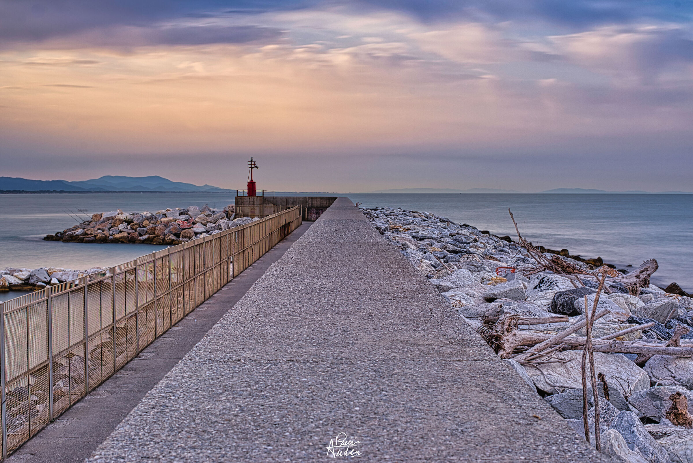 walk to the lighthouse of the port of Carrara...