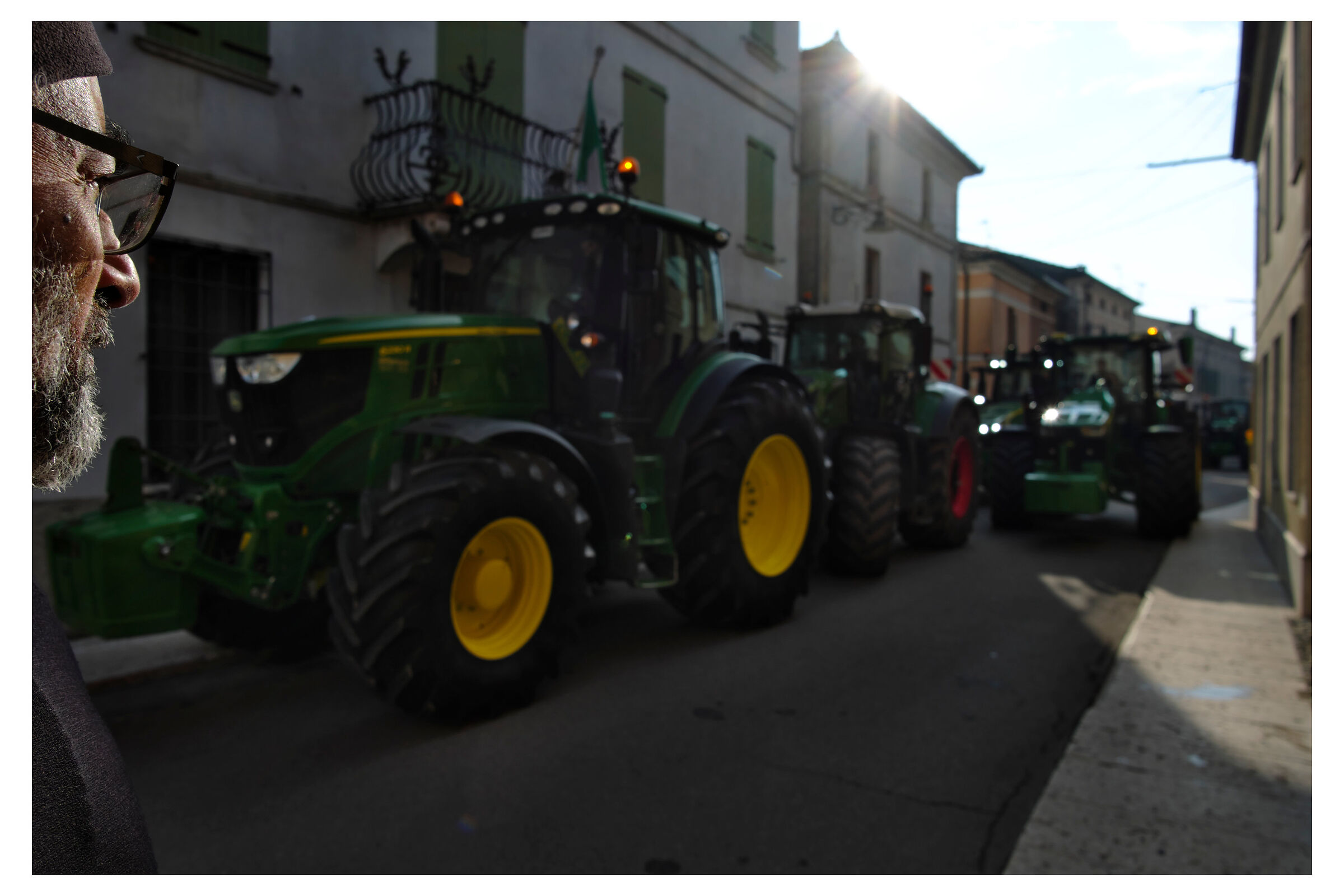Agricultural tractors in the historic center of Piubega....