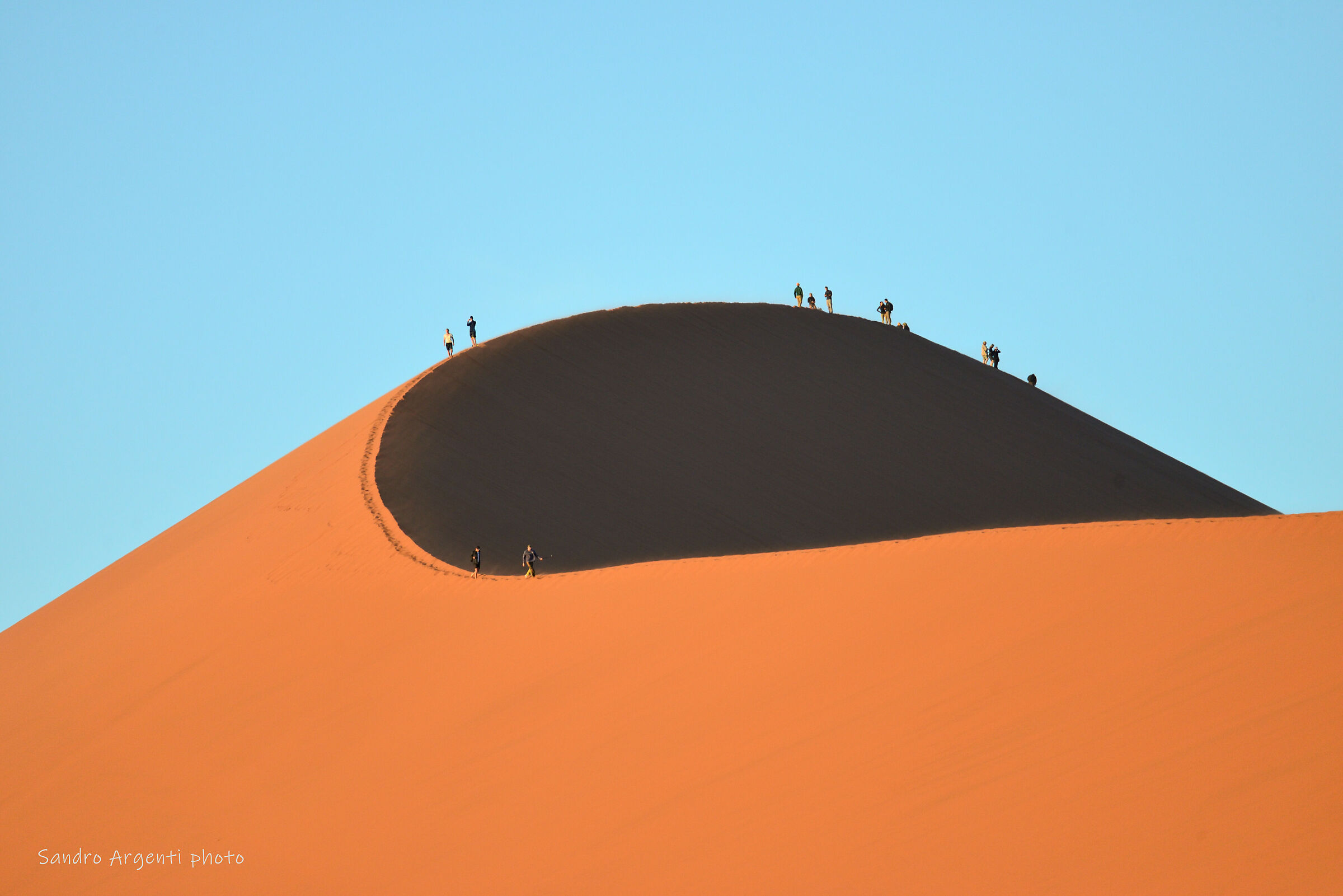 Walking on the crest of the dune. Namibia....