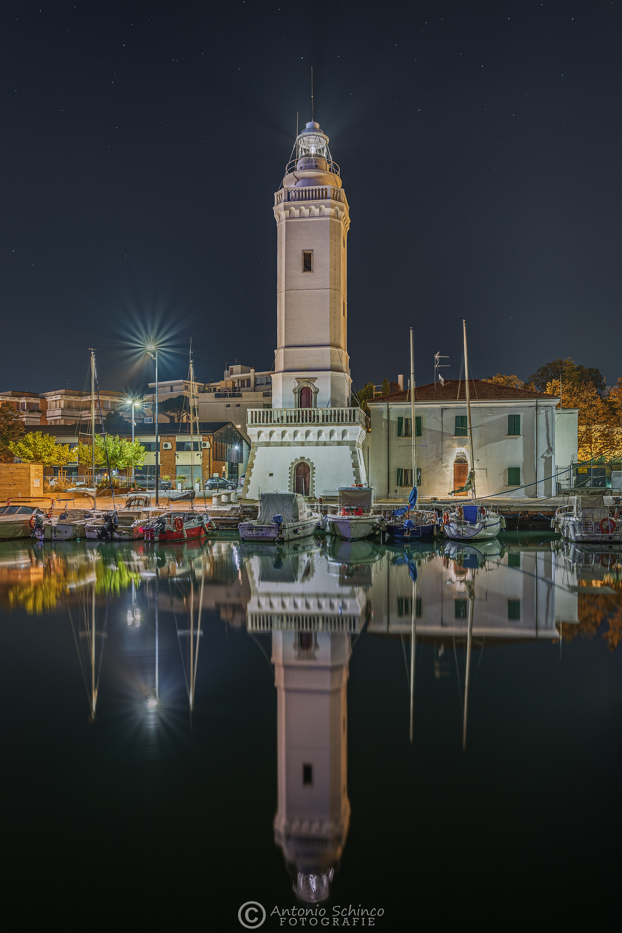 The lighthouse reflected in the waters of the Canal Port...